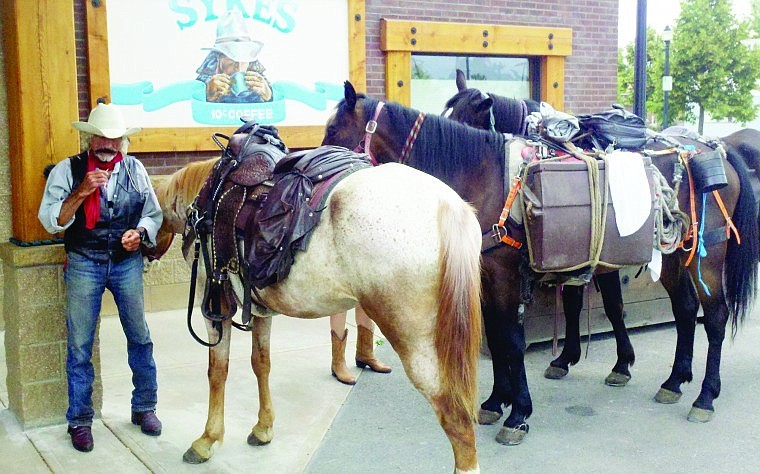 &lt;p&gt;Transcontinental cowboy Doc Mishler relaxes outside Sykes while preparing to head out of town with his horses, from left, Charity, Chief-Free-Spirit and Justice. He is riding across the country raising awareness for the issue of childhood hunger.&lt;/p&gt;