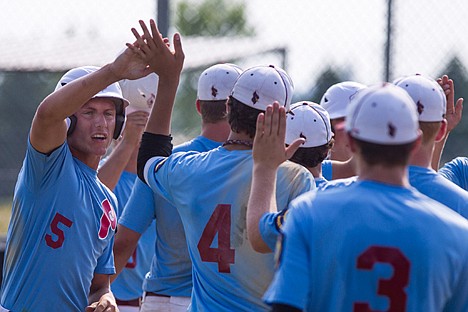&lt;p&gt;Jacob Koski gives teammate Logan Bruner a triumphant high-five as the Prairie boys celebrate a 13-5 victory against Lewis-Clark in the first game of a double-header on Tuesday at Post Falls High School.&lt;/p&gt;