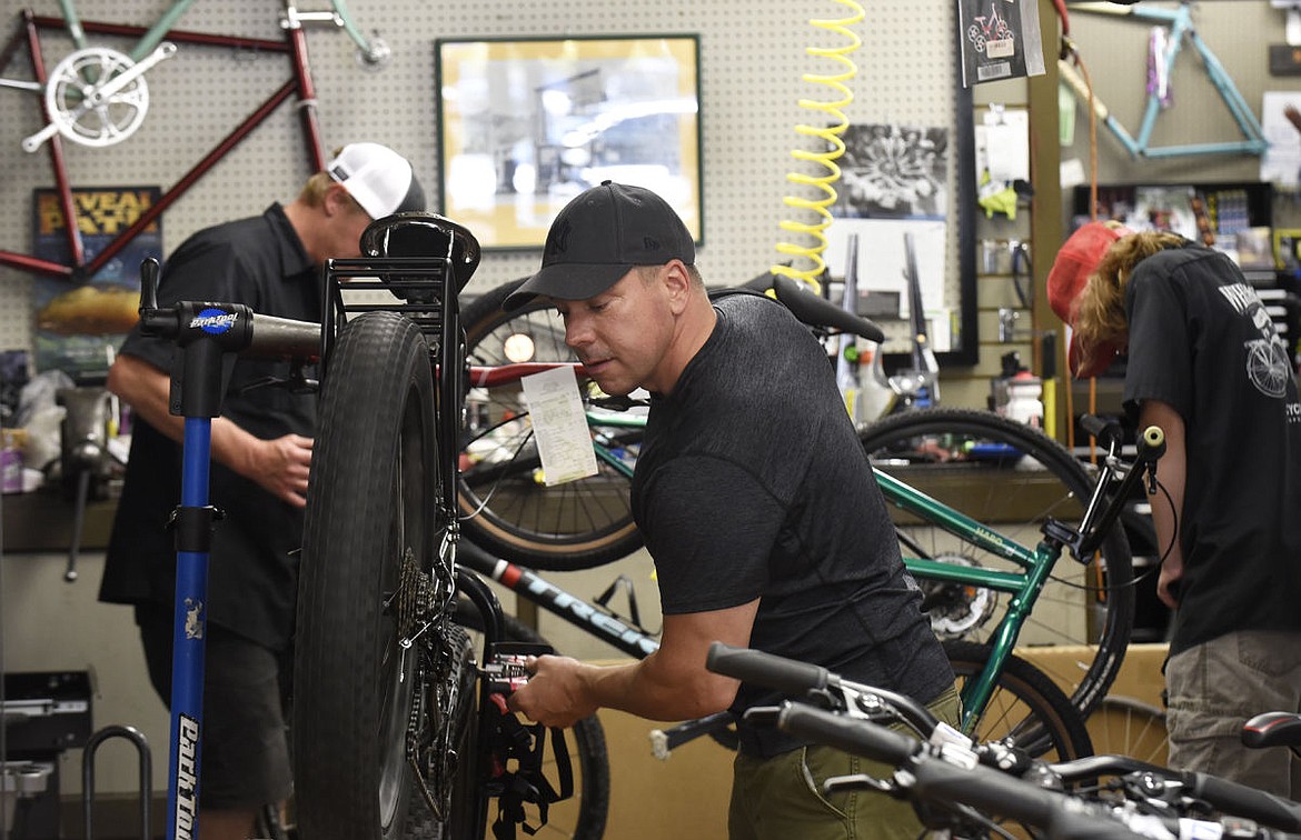 &lt;p&gt;Mike Potter puts a tire on his fat bike at Wheatons on Wednesday. The bike, which Potter rode across America on, was stolen from him about eight months ago. The bike was recovered after it was brought it to Wheatons to get repaired and Wheatons manager Hans Axelsen recognized it. (Aaric Bryan/Daily Inter Lake)&lt;/p&gt;