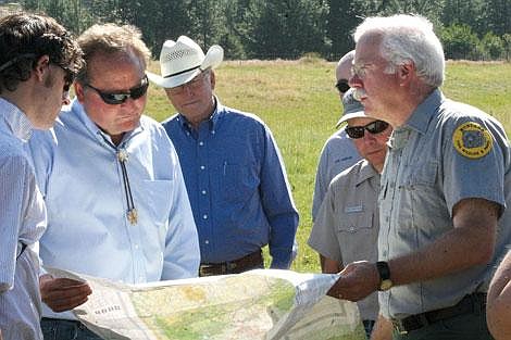 Jason Shueh/Valley Press Gov. Brian Schweitzer studies a map showing the location of the new Paradise fishing access site bought by the Fish Wildlife and Parks organization. The site will help create a float corridor from Thompson Falls to Missoula. Schweitzer was there to tour the new spot and to meet with local officials such as Jim Elliot, the state senator.