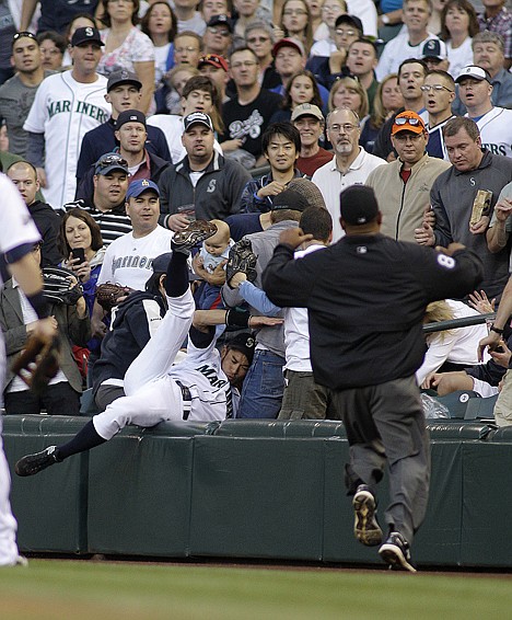 &lt;p&gt;Seattle's Ichiro Suzuki tumbles into the stands after trying to catch a foul ball in the sixth inning Saturday night. The Mariners lost to the visiting Texas Rangers 5-1.&lt;/p&gt;