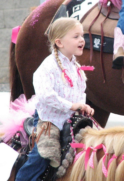 A young cowgirl participates in the Royal City SummerFest parade on Saturday.