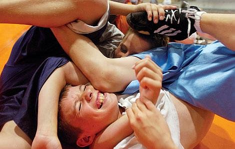 Cody Savage, 13, of Missoula is pinned by his friend Jacob Conklin ,13, of Missoula during a technique exercise at the Flathead Valley Wrestling Camp in Kalispell last week. The camp trains kids from elementary to high school in the physical and technical aspects of wrestling. Chris Jordan/Daily Inter Lake