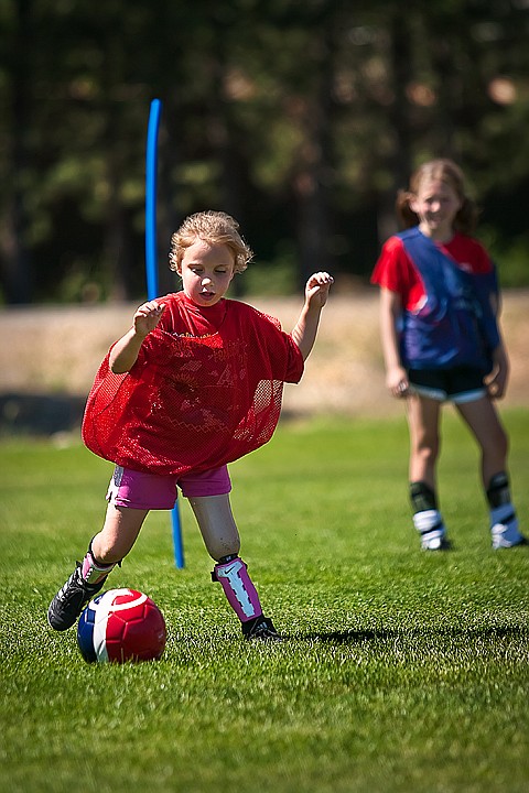 <p>Playing fierce defense, Isabelle James traps the balls and makes a pass to one of her teammates during a friendly game at the Skyhawks Soccer Camp Friday afternoon.</p>
