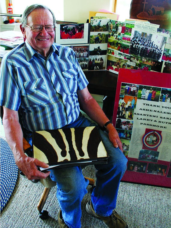 &lt;p&gt;&lt;strong&gt;Larry Passmore&lt;/strong&gt; sits in front of photo displays of students from the MaaSAE Girls Lutheran Secondary School in Tanzania. He holds a zipper binder made of zebra skin, a gift from staff at the school during one of his seven trips to the country. Passmore has made donations to the school for 20 years. (Hilary Matheson/Daily Inter Lake)&lt;/p&gt;&lt;div&gt;&#160;&lt;/div&gt;&lt;p&gt;&lt;strong&gt;&#160;&lt;/strong&gt;&lt;/p&gt;