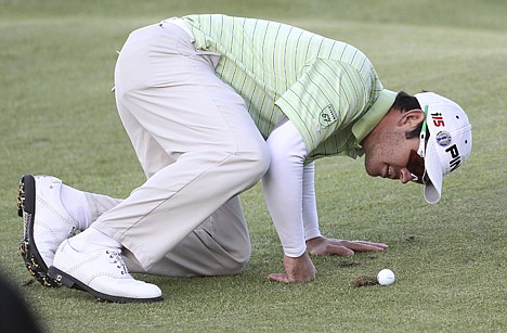 &lt;p&gt;Louis Oosthuizen eyes his ball as it rests on a grass clump in the 17th fairway during the third round of the British Open on the Old Course at St. Andrews, Scotland, on Saturday. The South African holds a four-shot lead over England's Paul Casey heading into today's final round.&lt;/p&gt;