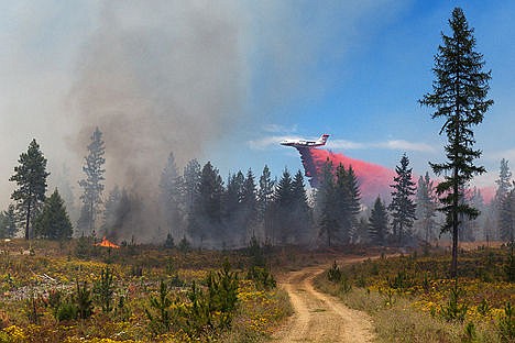 &lt;p&gt;An air tanker drops a load of retardant on a brush fire Friday between Spirit Lake and Athol.&lt;/p&gt;