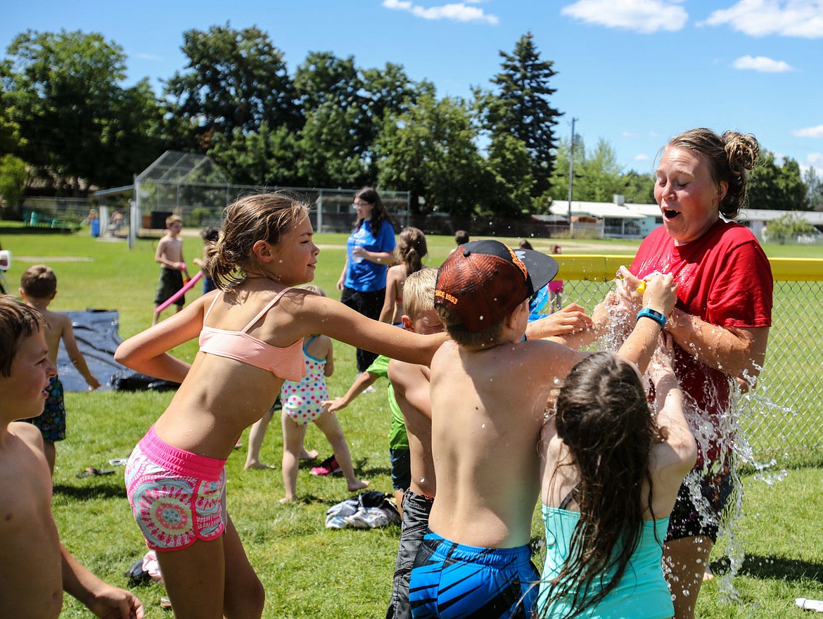 &lt;p&gt;KATIE HARTWIG/Press Madison Seymour, age 20, from Rathdrum is dosed with water from all directions on Friday in Post Falls. Seymour is one of the 24 full-time Americorps volunteers this summer.&lt;/p&gt;