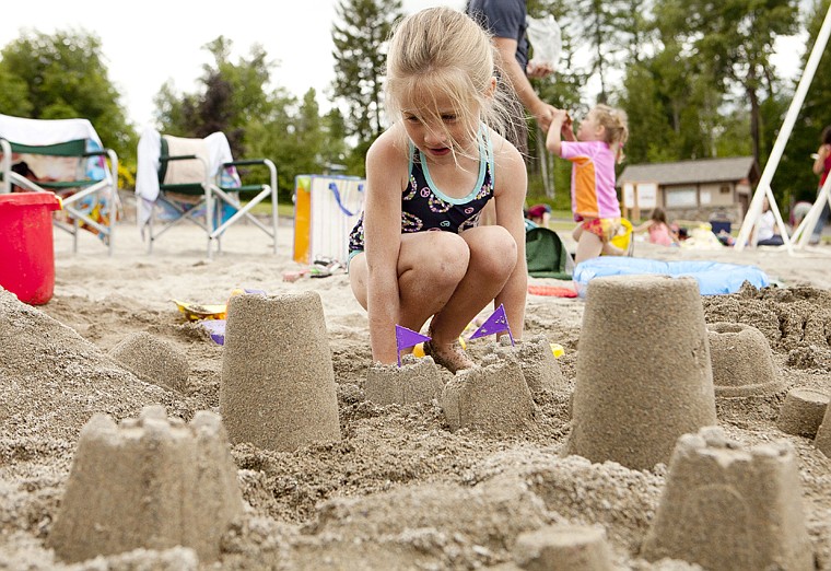 &lt;p&gt;Lucy Shea, 6, looks over her sand castle town she built for the
sand castle building competition sponsored by Whitefish Moms For
Moms at Whitefish City Beach Friday afternoon.&lt;/p&gt;