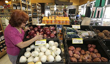 &lt;p&gt;Shopper Julia Esquivel picks onions at a local grocery store in the Little Havana area of Miami on June 12. The Labor Department reported on consumer prices for June on Friday.&lt;/p&gt;