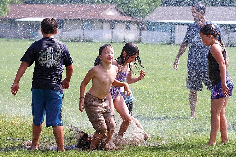 &lt;p&gt;Zeke Carter closes his eyes and basks in the cool spray of 2,700 gallons of water Thursday at Hayden Kinder Center with Kylie Tetzner, center, and Makayla Colhoff.&lt;/p&gt;
&lt;p&gt;Northern Lakes Fire District personnel blasted water on children attending the Coeur d&#146;Alene School District&#146;s CDA4Kids program. It is the eighth consecutive year that firefighters from Coeur d&#146;Alene or Northern Lakes have volunteered to cool the kids off.&lt;/p&gt;