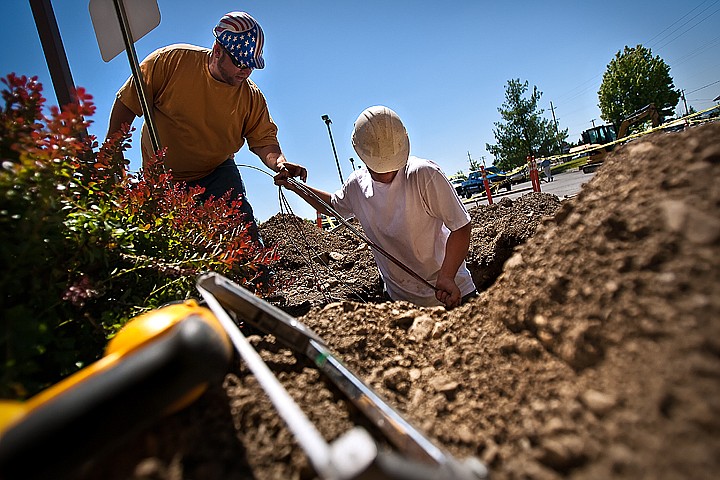 &lt;p&gt;BEN BREWER/Press Roger Sahli, left, takes a handful of wiring for new parking lot lighting from Matt Jacobs, right, outside the Kootenai County Sheriff's Office on Government Way. The new building is designed to make the building more handicap accessible and comply with the Americans with Disabilities Act standards for building construction.&lt;/p&gt;