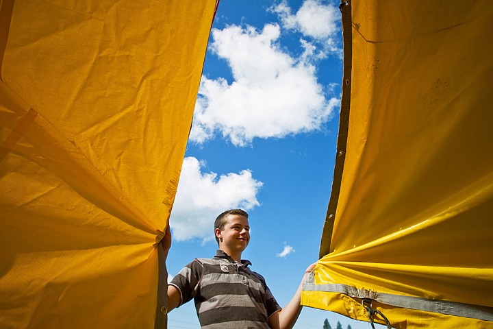 &lt;p&gt;SHAWN GUST/Press Boy Scout Jackson Hern, of Coeur d'Alene, holds two sections of a tarp as he and fellow scouts from troops 299 and 296 rebuild a tent for a garden booth Tuesday at the Art and Home Center. The tent was disassembled after beginning to tear in Monday's heavy winds.&lt;/p&gt;