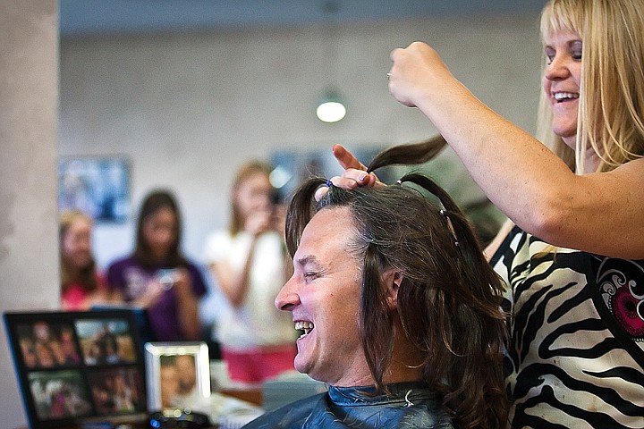 &lt;p&gt;BEN BREWER/Press Mitchell Olson, D.D.S. gives a hearty laugh while his hair is braided up by stylist Kim Carpenter in preparation for his Locks for Love donation at Nouveau Hair Studio. With his parents 60th anniversary coming up soon, he decided it was the right time to finally cut his hair after two years of long locks. Olson said,&quot;I don't care how old you get. Mother still runs the roost&quot;&lt;/p&gt;