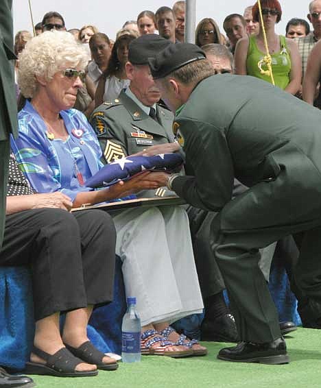 CUTLINE (Taps): Members of the United States Army Honor Guard salute Spc. Jeremiah Schmunk with a rendition of "Taps" and a 21-gun salute. Schmunk, a member of the Moses Lake unit of the National Guard, died in battle outside Baghdad July 9, and was buried in Warden last Saturday.<br> (Ceremony Begins) Members of the United States Army Honor Guard carry the casket containing the mortal remains of Warden-born Army Spc. Jeremiah Schmunk. Nearly 1,500 people showed up at Warden High School gymnasium to honor the memory of Schmunk, who died in combat outside Baghdad on July 9.<br> (Ceremony Begins 2): Members of the United States Army Honor Guard surround the casket of Army Spc. Jeremiah Schmunk, killed in combat outside Baghdad July 9. Nearly 1,500 people showed up at the Warden High School gymnasium to salute Schmunk, who had been born and raised in that city.<br> (Ceremony ends) Members of the United States Army Honor Guard carry the casket of National Guard Spc. Jeremiah Schmunk out of the Warden High School gymnasium, and on to the hearse that would take him to the Sunset Memorial cemetery. Schmunk, born and raised in Warden, was saluted one last time by his friends and neighbors, as well as by city, county and state authorities.