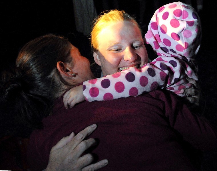 Von Jentzen gets a hug from Tiffany Stebbins (left) and Stebbin's three-year-old daughter Karmyn Flanagan, to whom the swim was dedicated to. Flanagan was diagnosed with acute lymphoblastic leukemia last November. Von Jentzen swim raised money to help cover the young girl's medical payments.