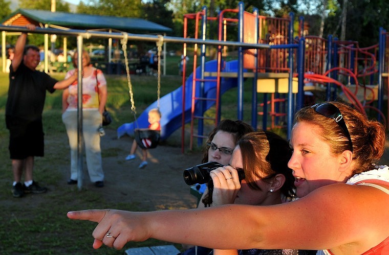 Family friend Amanda Ormesher points out in the distance to indicate to Tiffany Stebbins where she should be looking through the binoculars to see the pair of boats floating alongside Von Jentzen. Next to Stebbins is Amber Christopher.