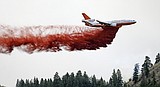 High winds push growing wildfire