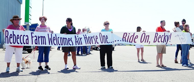 &lt;p&gt;Six people hold a banner on the tarmac Tuesday at Glacier Park
International Airport to greet a Boeing 727 dubbed Air Horse One.
The jet carried 19 horses and 13 riders. The Event at Rebecca Farm
starts Thursday.&lt;/p&gt;