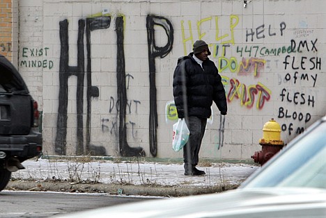 &lt;p&gt;In a Dec. 12, 2008 photo, a pedestrian walks by graffiti in downtown Detroit. On Thursday, Detroit became the largest city in U.S. history to file for bankruptcy.&lt;/p&gt;