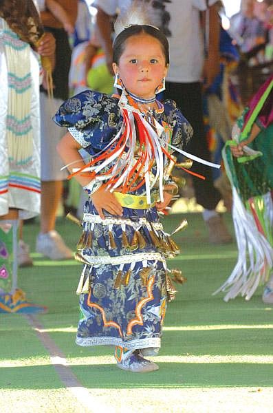 Three-year-old Mariam Daniels of Helena dances during the grand entry of the Standing Arrow Pow Wow in Elmo this past Friday. Mariam and sister Sephra are of the Cree Tribe.