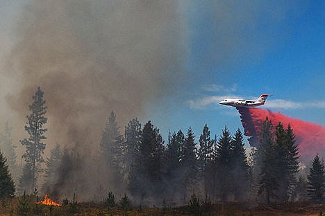 &lt;p&gt;An air tanker drops retardant on a brush fire near Spirit Lake last week. Resources used to fight wildfires are well above annual averages.&lt;/p&gt;