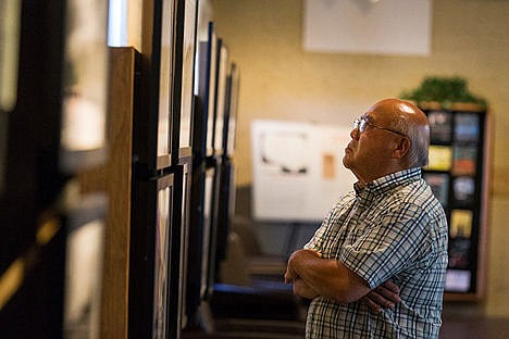 &lt;p&gt;Keiji Shimizu studies World War II era photographs of a Japanese internment camp in Idaho at the Human Rights Education Institute&#146;s &#147;Uprooted&#148; exhibit Monday in Coeur d&#146;Alene.&lt;/p&gt;