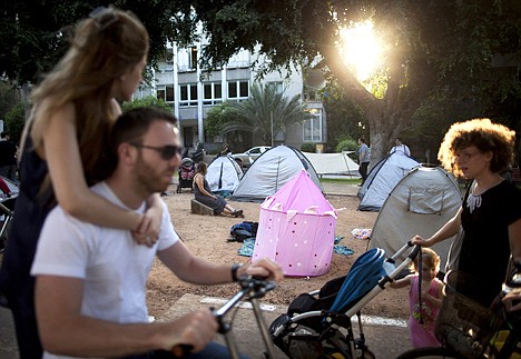 &lt;p&gt;In this photo taken on Monday, July 18, 2011, Israelis pass by a protest tent encampment in central Tel Aviv, Israel. First came a revolt over cheese that forced Israel's largest dairy companies to lower their prices. Now, with consumer rage mounting over what is widely seen as a staggering cost of living, tent camps have sprung up across Israel to protest housing prices that climbed even as costs fell globally amid the world's financial meltdown. (AP Photo/Oded Balilty)&lt;/p&gt;