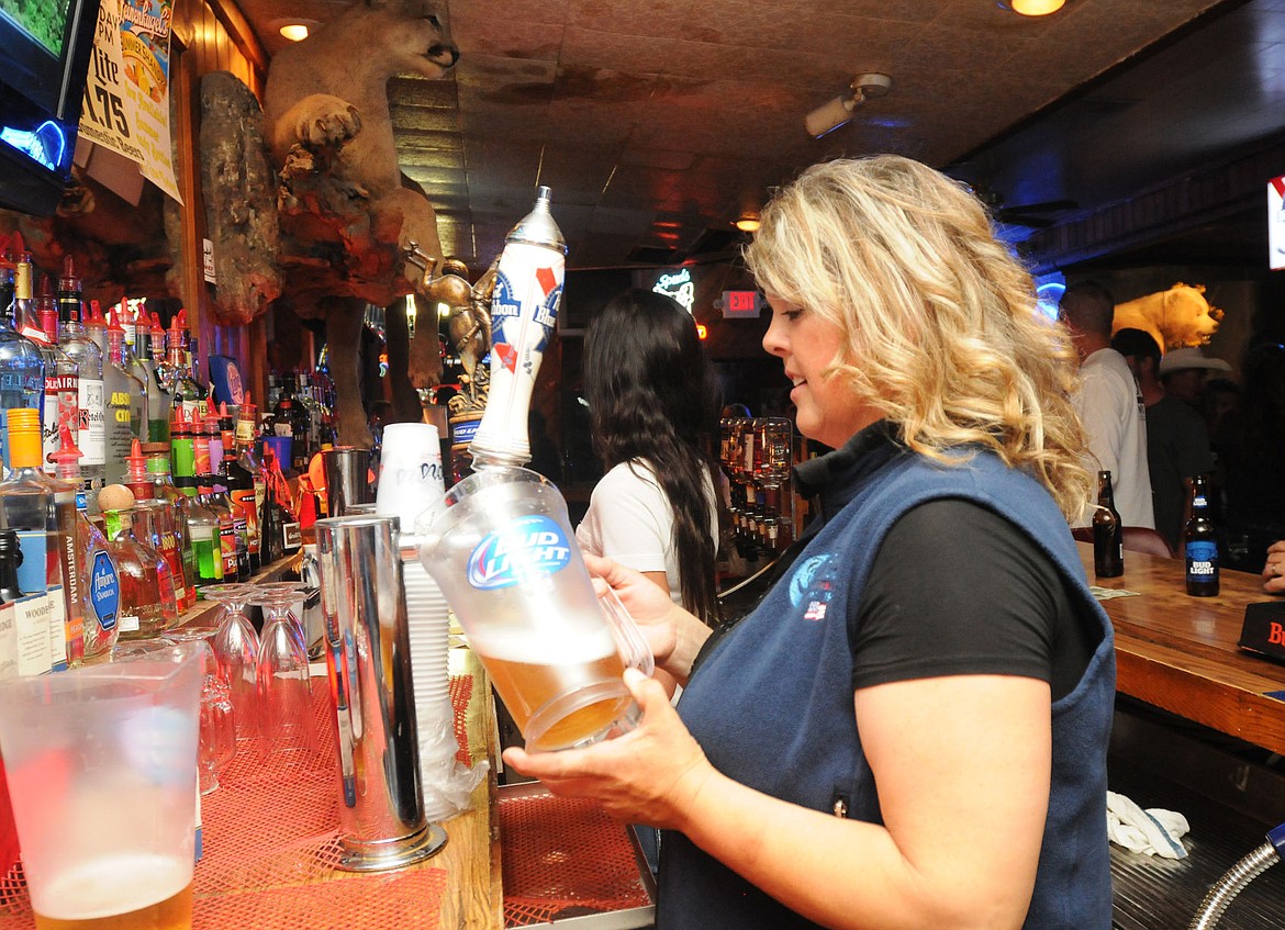 &lt;p&gt;Charlene Sapa fills a pitcher of beer at the Blue Moon on Saturday.&lt;/p&gt;