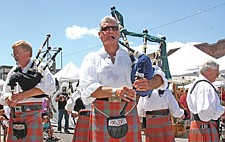 Dick Brantor, left, Josh Hamilton, center and Richard Luepke, right, perform as part of the Great Scots Pipes and Drums band during the Cherry Festival last weekend in Polson.