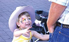 2-year-old Landyn Hughes, of Polson, goes for a hug during the Cherry Festival last weekend in Polson.