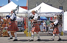 Josh Hamilton, Dick Brantor and Sandy Ferrell of the Great Scots Pipes and Drums band marches down Main Street during the Cherry Festival last weekend in Polson.