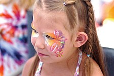 4-year-old Klo'E Kipp, of St. Ignatius, gets a new paint job during the Cherry Festival last weekend in Polson.