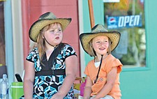 Charlie Frost and Shevonne Devons, both of Arizona, hang out in the shade during the Cherry Festival last Friday in Polson.