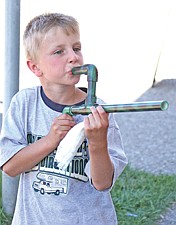 7-year-old Trevor Bartel, of Ronan, tests out the latest addition to his armament, a mashmellow shooter, at the Cherry Festival last weekend in Polson.