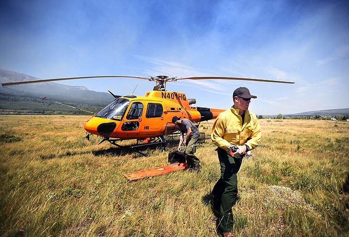 &lt;p&gt;Jeff Hueser, pilot, and Bert Smith, helicopter manager of the Flathead Helitack crew out of Hungry Horse, prepare to fly over the Reynolds Creek Fire on Wednesday, July 22, in East Glacier. The crew was flying missions to drop water where needed and be on the look out for park visitors who need to be evacuated to safety. (Brenda Ahearn/Daily Inter Lake)&lt;/p&gt;