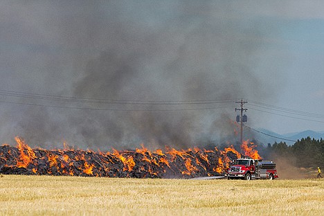 &lt;p&gt;A stack of hay worth tens of thousands burns as Kootenai County Fire and Rescue douse the area around the fire to keep it from spreading.&lt;/p&gt;