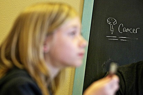 &lt;p&gt;With a sketch of a screw next to the word cancer written on a chalk board in the Caro home, the small display serves as a mantra for how the family is facing Heather's bout with breast cancer.&lt;/p&gt;