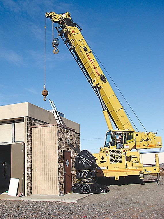 A crane removes equipment from Othello's Well Six well house
through an opening in the roof. A rehabilitation of the well was
recently completed.