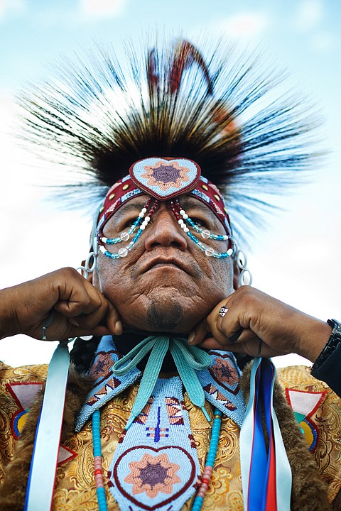 &lt;p&gt;Kermit Davis, of Nespelem, Washington, ties on a roach made of
porcupine hair and pheasant feathers while he finishes dressing in
traditional Nez Perce regalia.&lt;/p&gt;