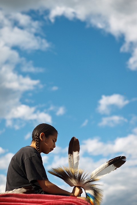 &lt;p&gt;Desmond Madera, 12, of the Blackfeet and Colville tribes,
handles with his headdress prior to the Julyamsh pow wow.&lt;/p&gt;