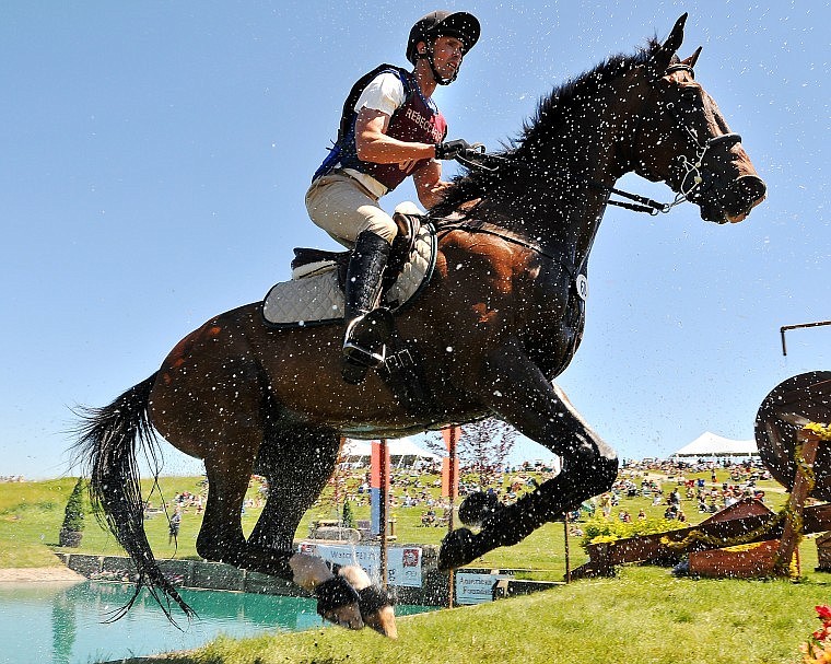 Nathan Grosse jumps out of the pond on his horse Ray.