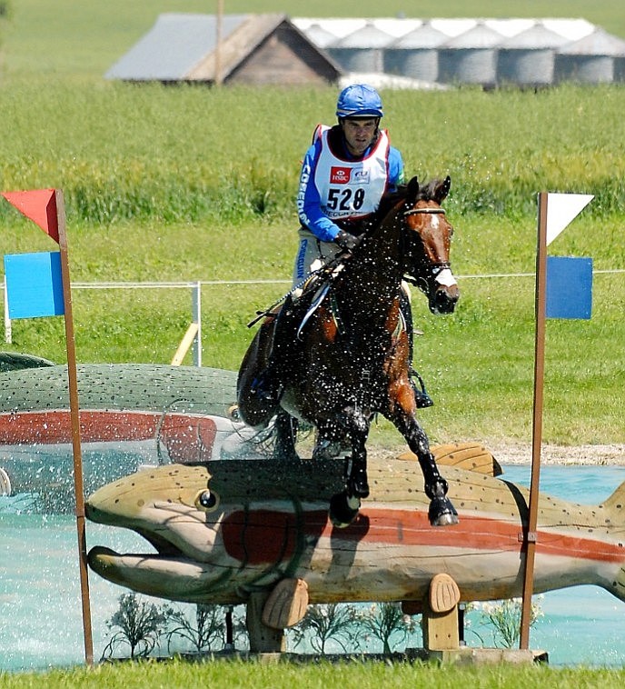 Phillip Dutton jumps out of the Trout Pond on his horse Inmidair