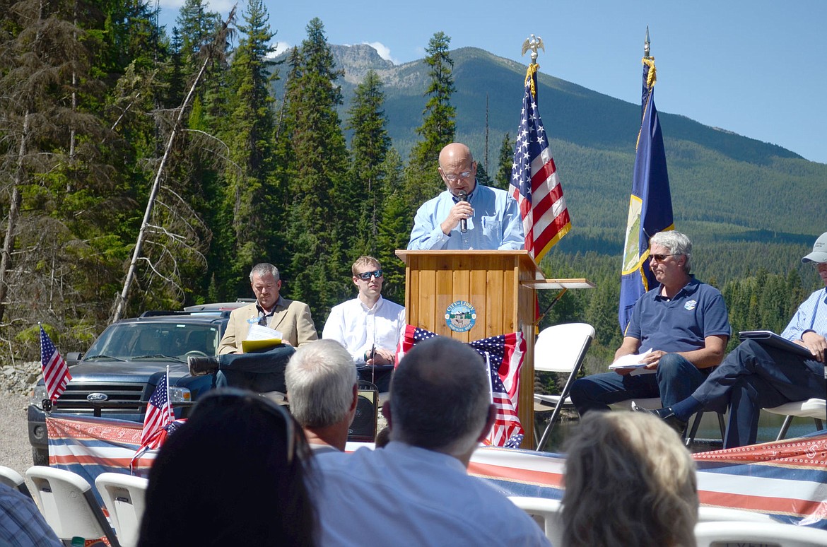 &lt;p&gt;Libby Mayor Doug Roll speaks at the Flower Creek Dam dedication on Wednesday. On stagen from left: Lad Barney, of the United States Department of Agriculture Rural Development office, Chad Campbell, representative for Sen. Jon Tester, John Tubbs, director of the Department of Natural Resource and Conservation, and Bob Morrison, president of Morrison-Maierle, each spoke at the event. (Seaborn Larson/The Western News)&lt;/p&gt;
