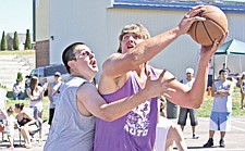 Ruben Cutfinger, of St. Ignatius, plays some tough defense on Joey Ray, of Charlo, during the Good Old Days 3-on-3 basketball tournament last Saturday in St. Ignatius.