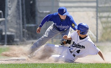 <p>Mission Valley's Derek Peel is tagged out trying to steal third base by Libby's Luke Haggerty in the Mariners' 11-0 victory over the Loggers in their opening game at the American Legion Western A District Tournament Wednesday. (Aaric Bryan/Daily Inter Lake)</p>
