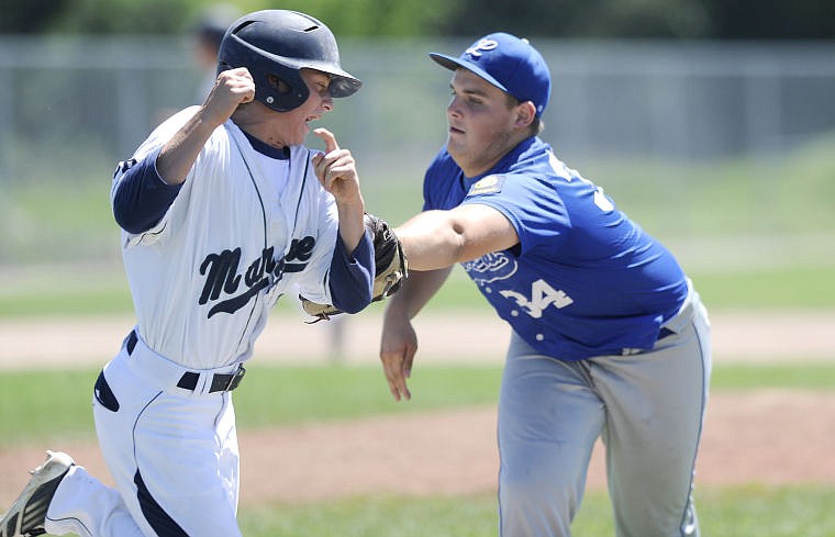 <p>Mission Valley's Trevor Paro is tagged out by Libby's Austin Marshall after he layed down a bunt to move to runners over in the Mariners' 11-0 victory at he American Legion Western A District Tournament Wednesday. (Aaric Bryan/Daily Inter Lake)</p>