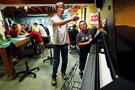 &lt;p&gt;Chris Jenkins, 12, and Richard Peterson, 17, close the lid to a thermal printer while printing custom stickers Friday at AHA! Creative during a design workshop for Project Safe Place clients.&lt;/p&gt;