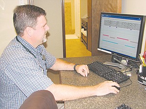 Dr. Eric Haeger looks at information from a sleep study at the new Moses Lake branch of the Central Washington Sleep Diagnostic Center