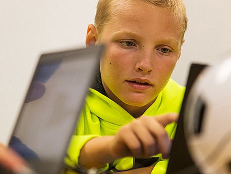 &lt;p&gt;Mason Cummings, 12, works on programming a robotics code on a laptop.&lt;/p&gt;